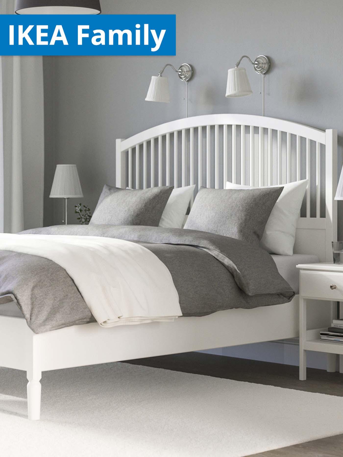 White TYSSEDAL bed frame in bedroom