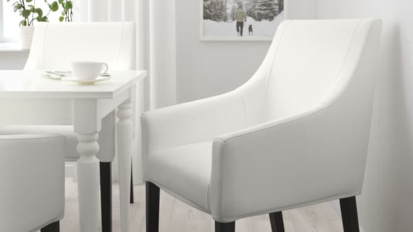 White un-upholstered dining chairs around a white table