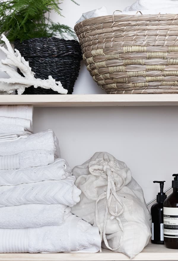 Wicker and rattan baskets on a shelf.