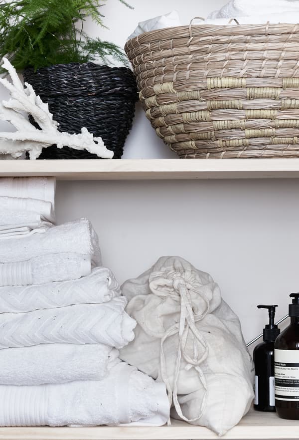 Wicker and rattan baskets on a shelf.
