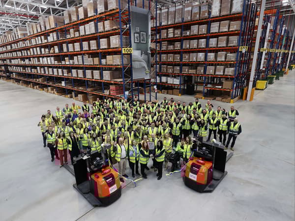 Wide shoot of the interior of the distribution centre. Two forklifts in the foreground.