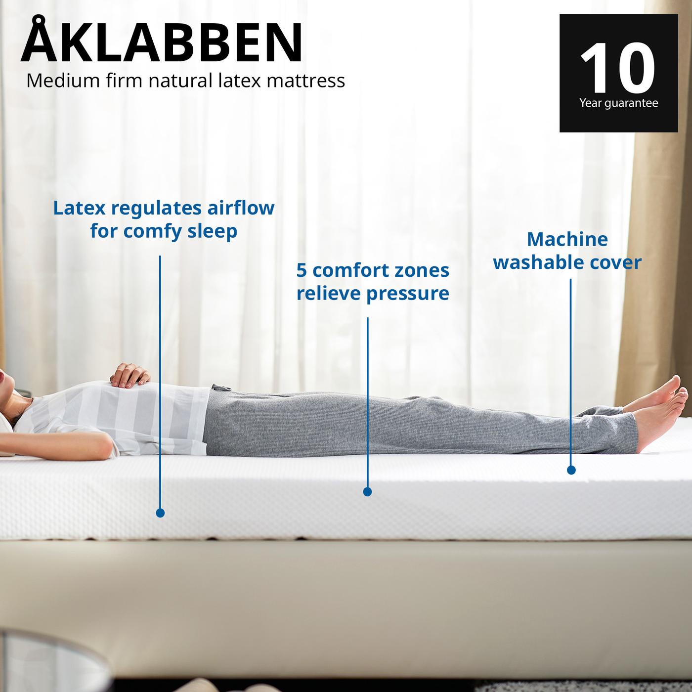 Wide shot of a woman lying sideways on a AKLABBEN mattress highlighting the benefits. Comes with 10 year guarantee.