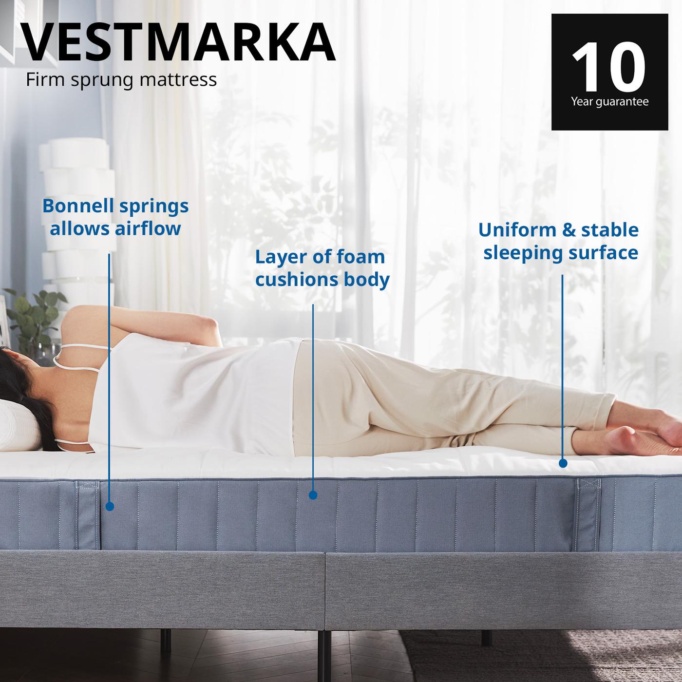 Wide shot of a woman lying sideways on a VESTMARKA sprung mattress highlighting the benefits. Comes with 10 year guarantee.
