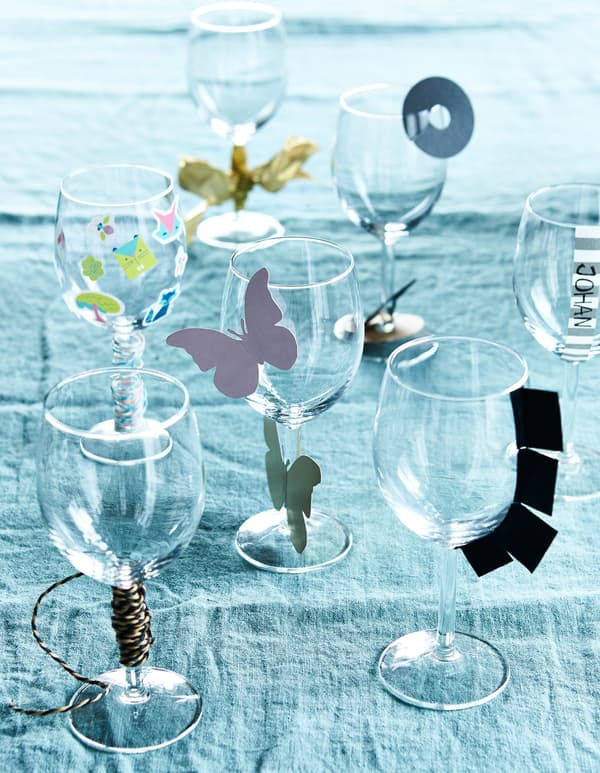 Wine glasses decorated with hand-made paper decorations.