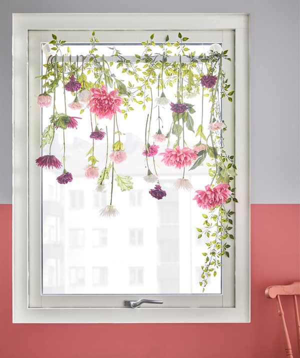 With STUGVIK suction cup towel rack from IKEA and some artificial flowers, you can create an easy window treatment. The suction cups grip tightly to glass without any drilling. We wrapped on fake flowers and vines like white carnations and pink dahlias.