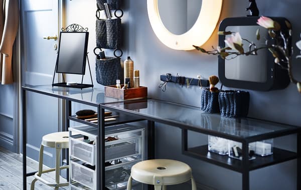 With the help of a narrow table, two stools, some organisers, trolleys and a lighted mirror you can make a hair and makeup station.