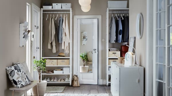 Wohnbereich mit einem weißen Aufbewahrungssystem für Kleidung, Bücher & mehr.