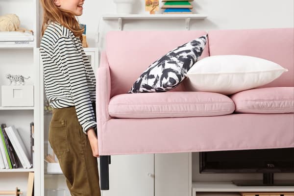 Woman carrying an IKEA sofa