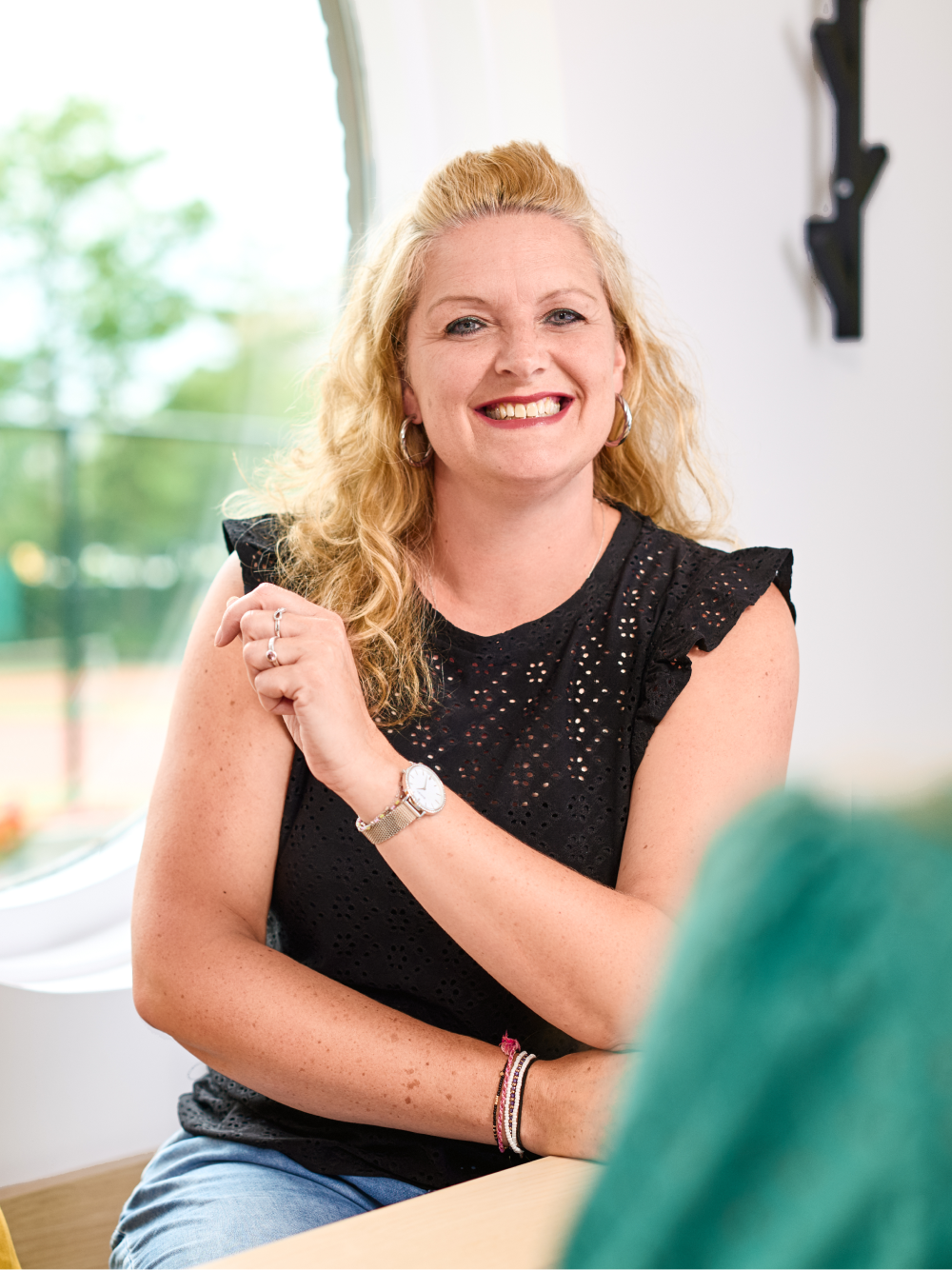 Woman in a black top smiling at the camera