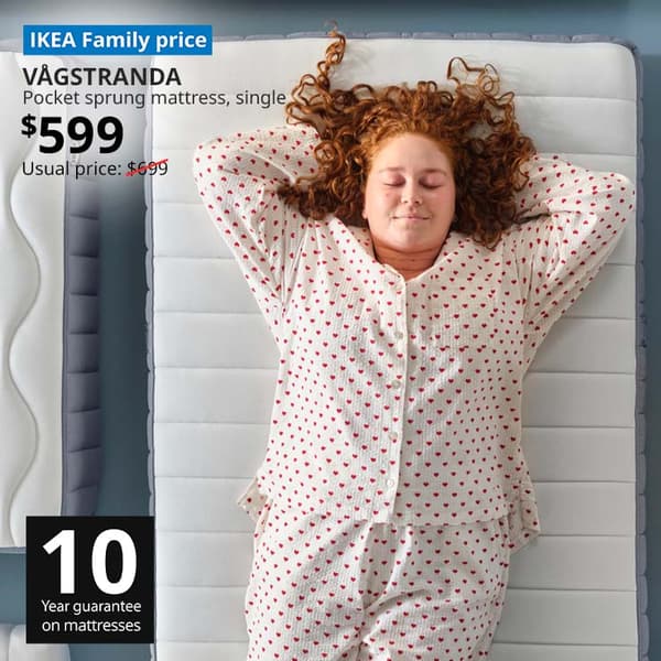 Woman in pajamas lying on VAGSTRANDA pocket sprung mattress, $599. 10 year guarantee.