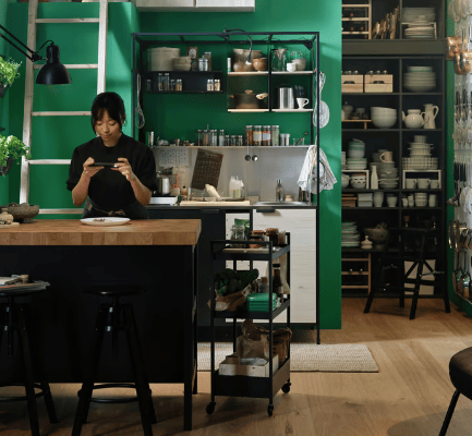Woman photographing her meal in small kitchen