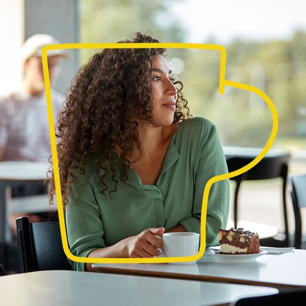 Woman sitting in a restaurant drinking coffee