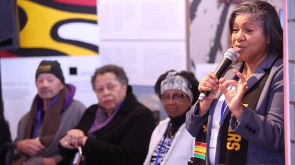 Woman speaking into a microphone