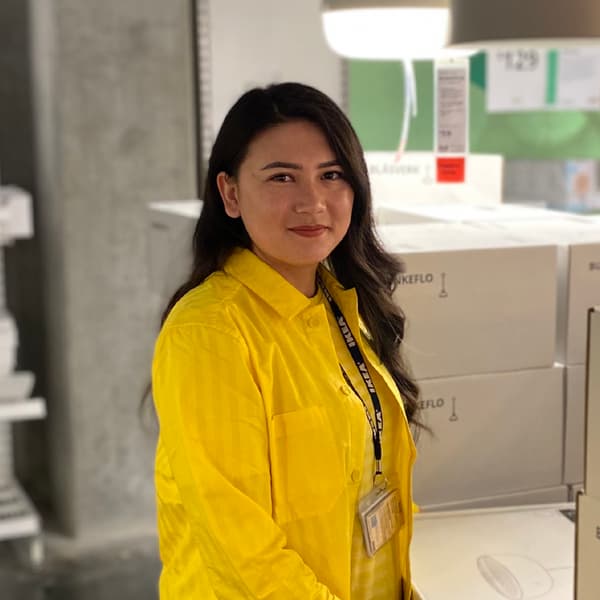 woman standing in yellow shirt