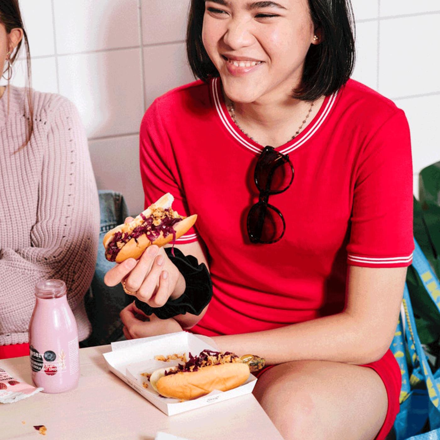 women eating food from bistro