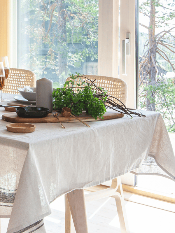 Wooden table and chairs with a linen table cloth 