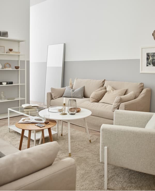 Woods, creamy white, and glass create a relaxing and organic feeling living room.