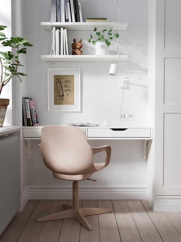 Workspace made up of an EKBY ALEX wall shelf, an ODGER chair, a lamp, and shelves in a niche between a corner and a wardrobe.