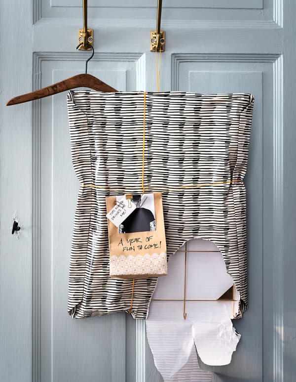 Wrap a present or cover a moodboard with IKEA ÖVERFLÖD gift wrapping paper, which is made of recyclable materials and designed with modern black and white striped patterns.