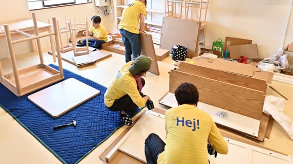 椅子やデスクを組み立てている。