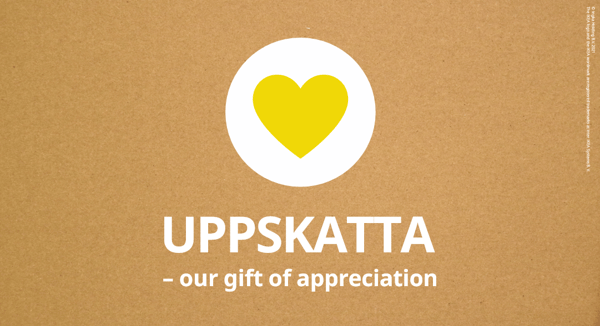 yellow heart in white circle on natural coloured background with the words UPPSKATTA - our gift of appreciation