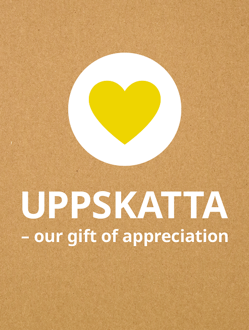 yellow heart in white circle on natural coloured background with the words UPPSKATTA - our gift of appreciation