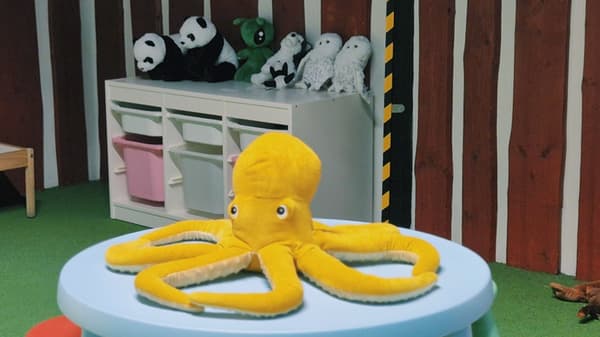 Yellow soft toy octopus on a table