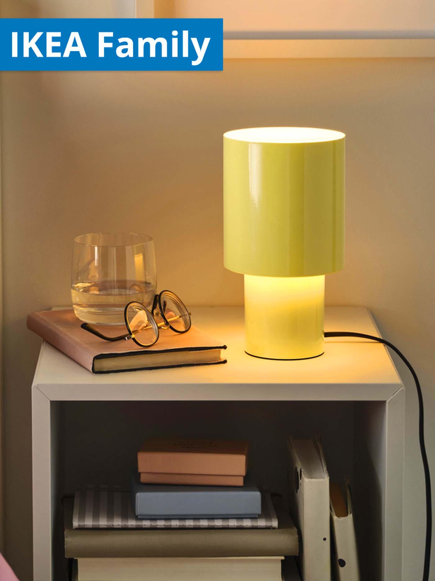 Yellow SPETSBOJ dimmable lamp on bedside table in bedroom