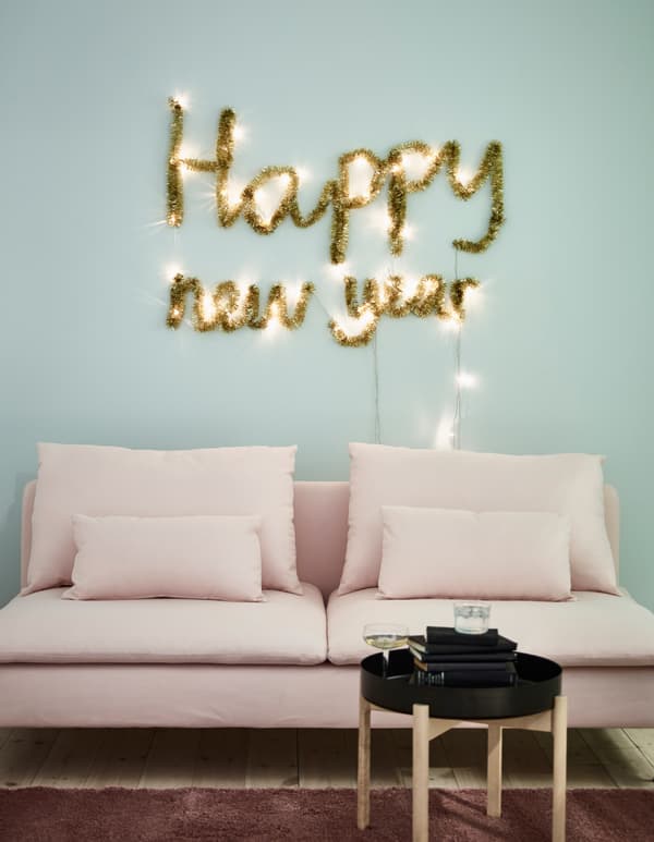 You can make new year wall decorations from holiday decor like SÄRDAL battery-operated LED light chains and gold garland from IKEA. Use the lights to pin up your new year mantra. Wrap garland around the lights so the message shines all the time.