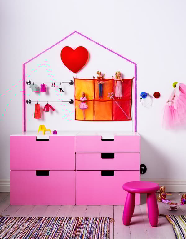 You can use IKEA furniture to encourage children’s role play. These side-by-side STUVA chests of drawers for children have white frames and pink drawer fronts. Their drawers can be a dollhouse, too.