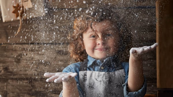 Young boy playing with white dust