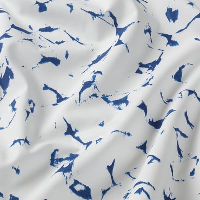 Blue patterned cotton bedding set including two pillows and a fitted sheet.