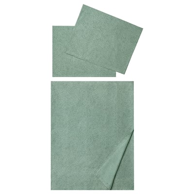 Two green, dotted, rectangular fabric sheets, one folded, one unfolded, soft and cool to touch, made of cotton and lyocell.