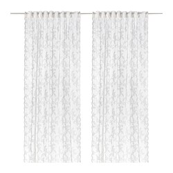 Pair of white lace curtains with floral pattern and curved edges for sheer, elegant privacy.