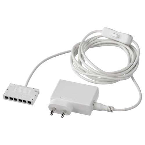A white ANSLUTA power adapter with a long cord and switch. It controls up to 6 light sources with one switch. Made of polycarbonate plastic.