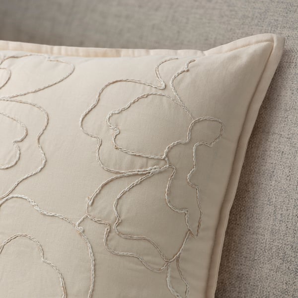 Decorative beige cushion cover with intricate abstract floral embroidery, made from soft cotton with recycled polyester tape.