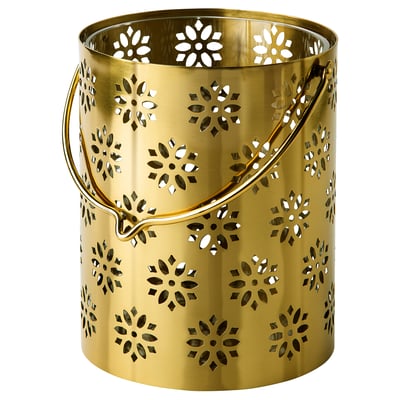 Golden metal lantern with floral cutouts. Round with handle, decorative and festive for ambiance.