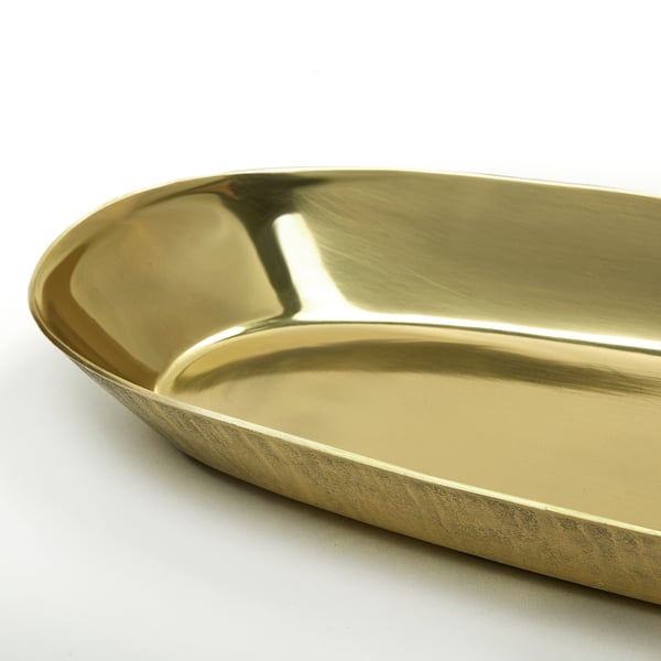 Gold oval dish with glossy interior and textured exterior. Raised edges, sleek design.