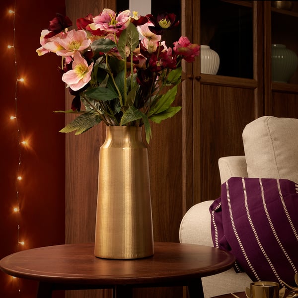 Gold AROMATISK vase with flowers on wooden table; large, elegant, rustic design.