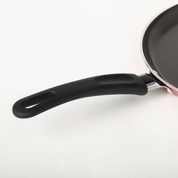 Close-up of premium nonstick pan handle, ergonomic design, black silicone grips securely, sleek kitchen tool.
