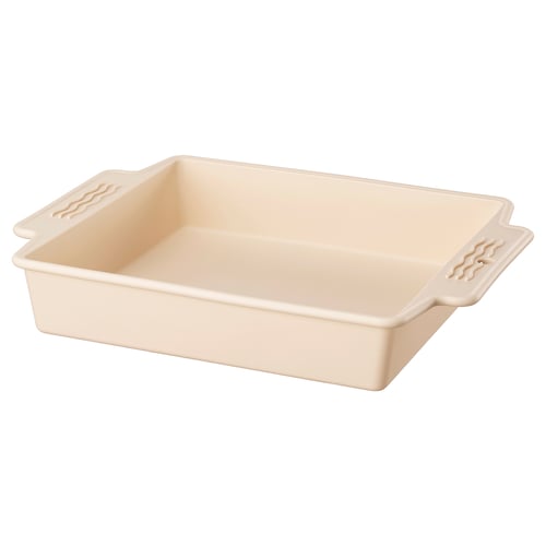 A beige BAKTIDER oven-safe silicone baking pan with handles.