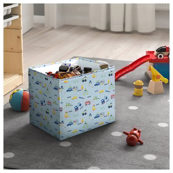 Childrens toy bin with blue, yellow, and green vehicle pattern.