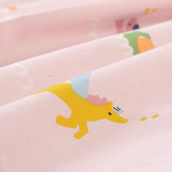 Close-up of soft pink bedsheet with whimsical yellow unicorn print, showcasing quality cotton blend texture.