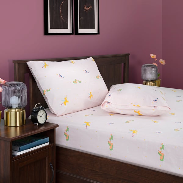 Pink BARNDRÖM unicorn bed sheets including large bed cover and pillowcase, against magenta wall with art.