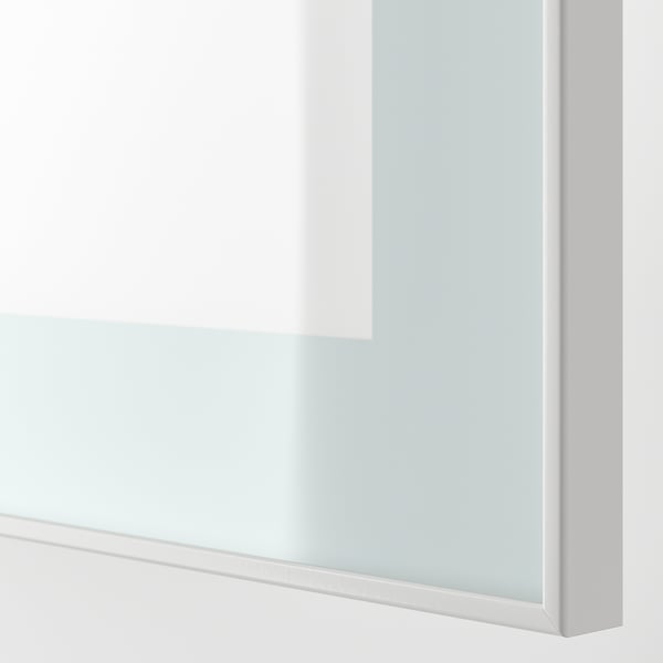 Close-up of modern, sleek white cabinet with glass door showing soft-close hinge.