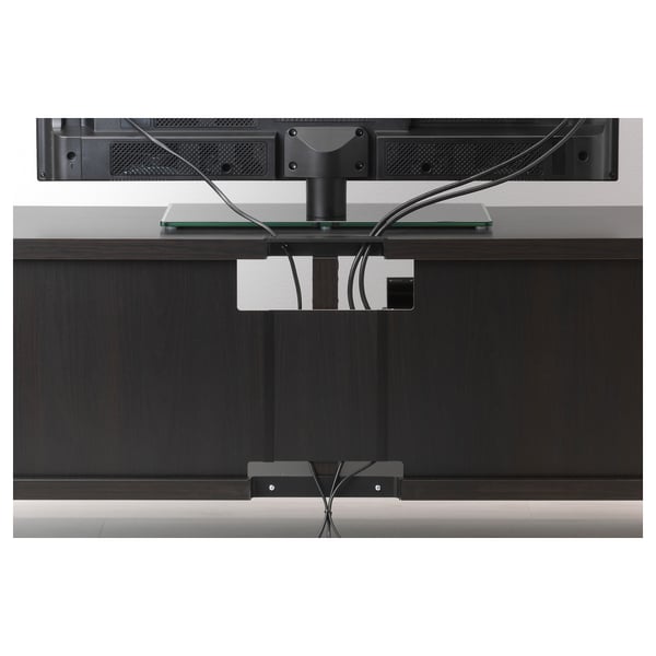 Dark wood tv stand with glass top, hiding cables behind, two drawers, wall-mountable.