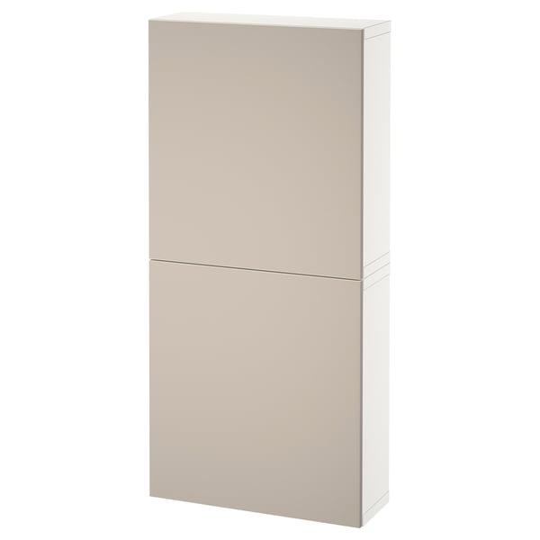 A tall, beige BESTÅ storage cabinet with two doors, mounted on a wall. The cabinet a minimalist design with clean lines and a smooth, flat surface.