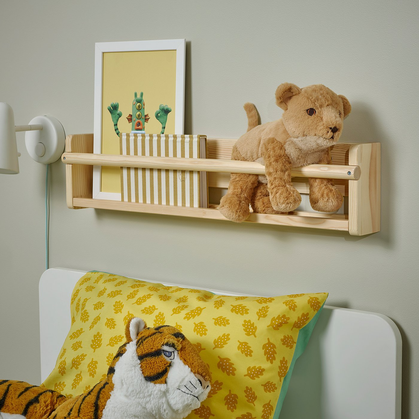 Wall shelf above bed with teddy bear and 1, 2, 3 poster, yellow pillows.