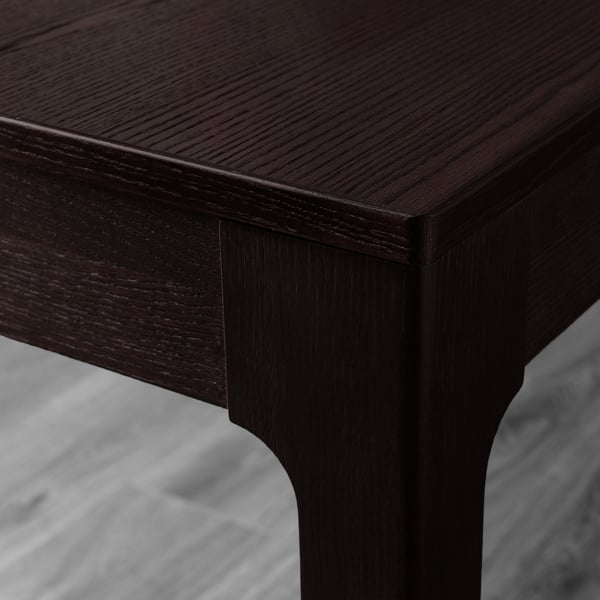 Dark wood table corner, polished and seamless, showcasing quality craftsmanship.