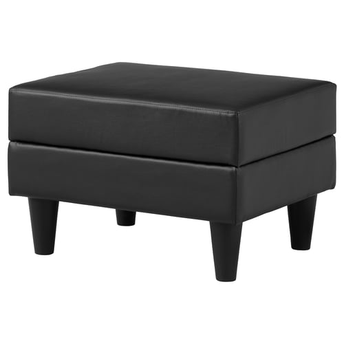 Black square footstool, leather-like, four tapered legs.